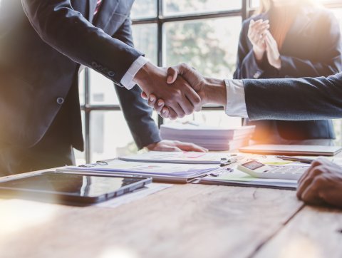 Salesman closing deal with handshake