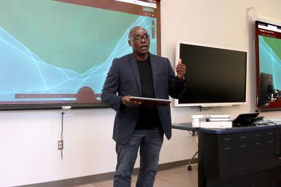 Professor lecturing at whiteboard
